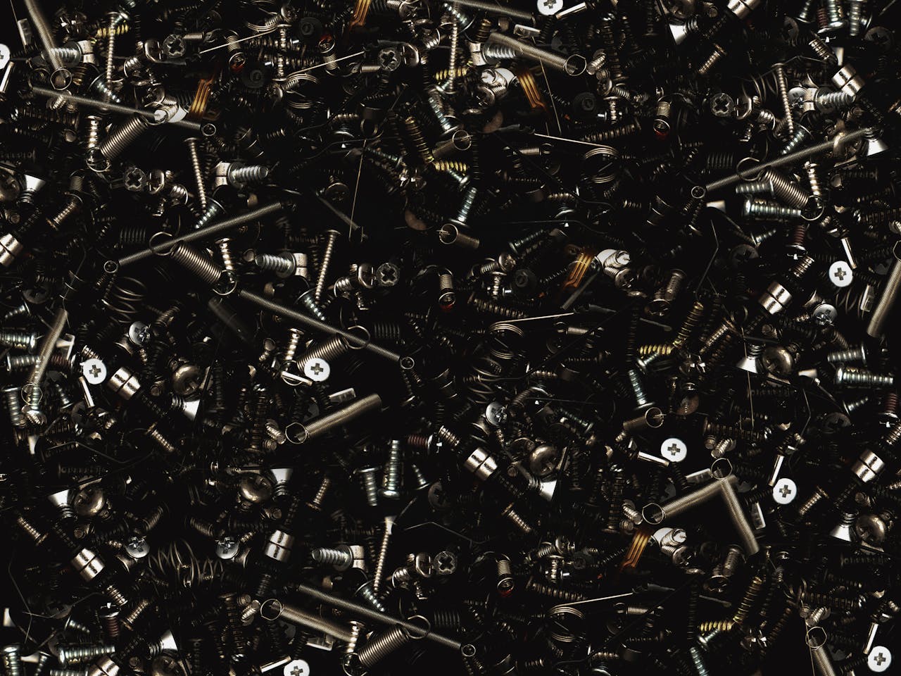 A detailed close-up view of various metal screws and bolts, showcasing industrial hardware.